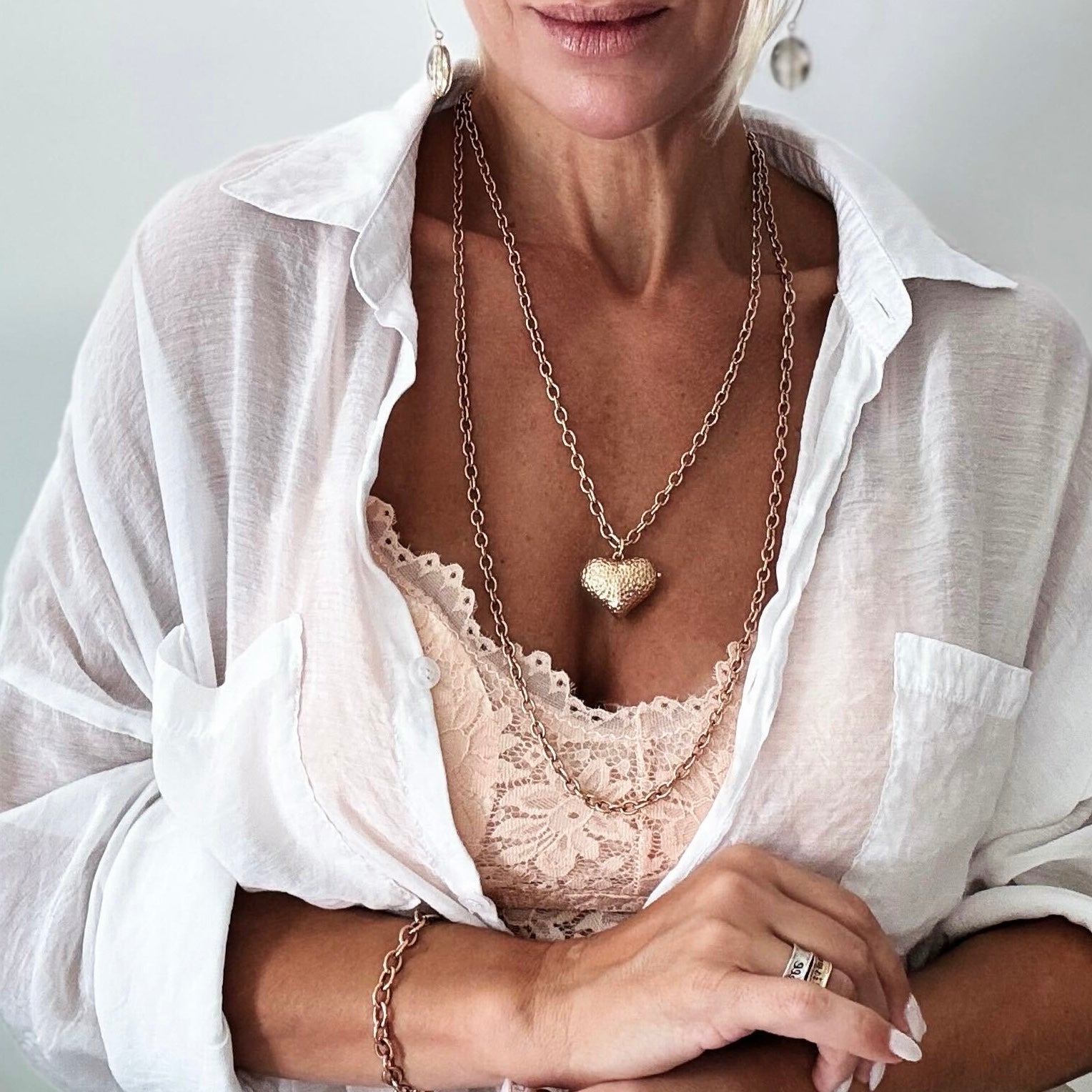 Katia Designs antique gold Follow Your Heart heart locket essential necklace with intricate heart pendant on a delicate chain.