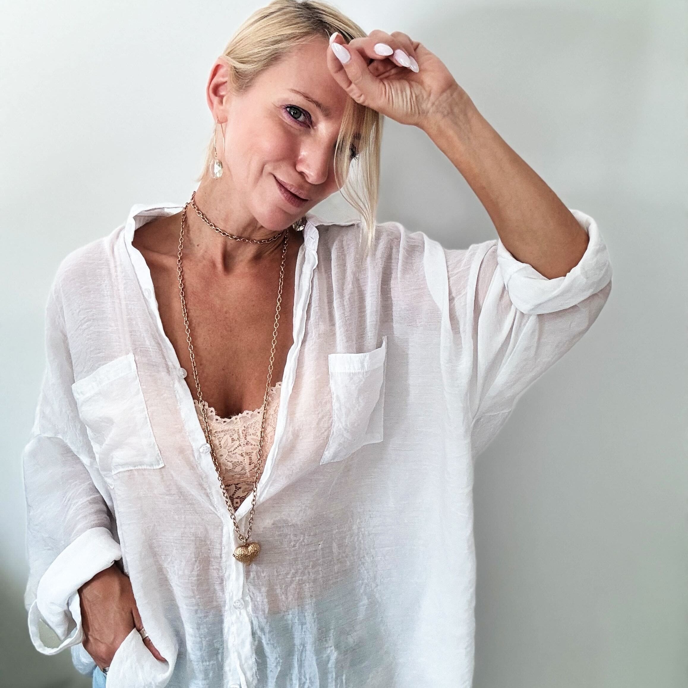 Katia Designs Follow Your Heart Heart Locket Essential Necklace in antique gold, showcasing a delicate heart-shaped pendant.