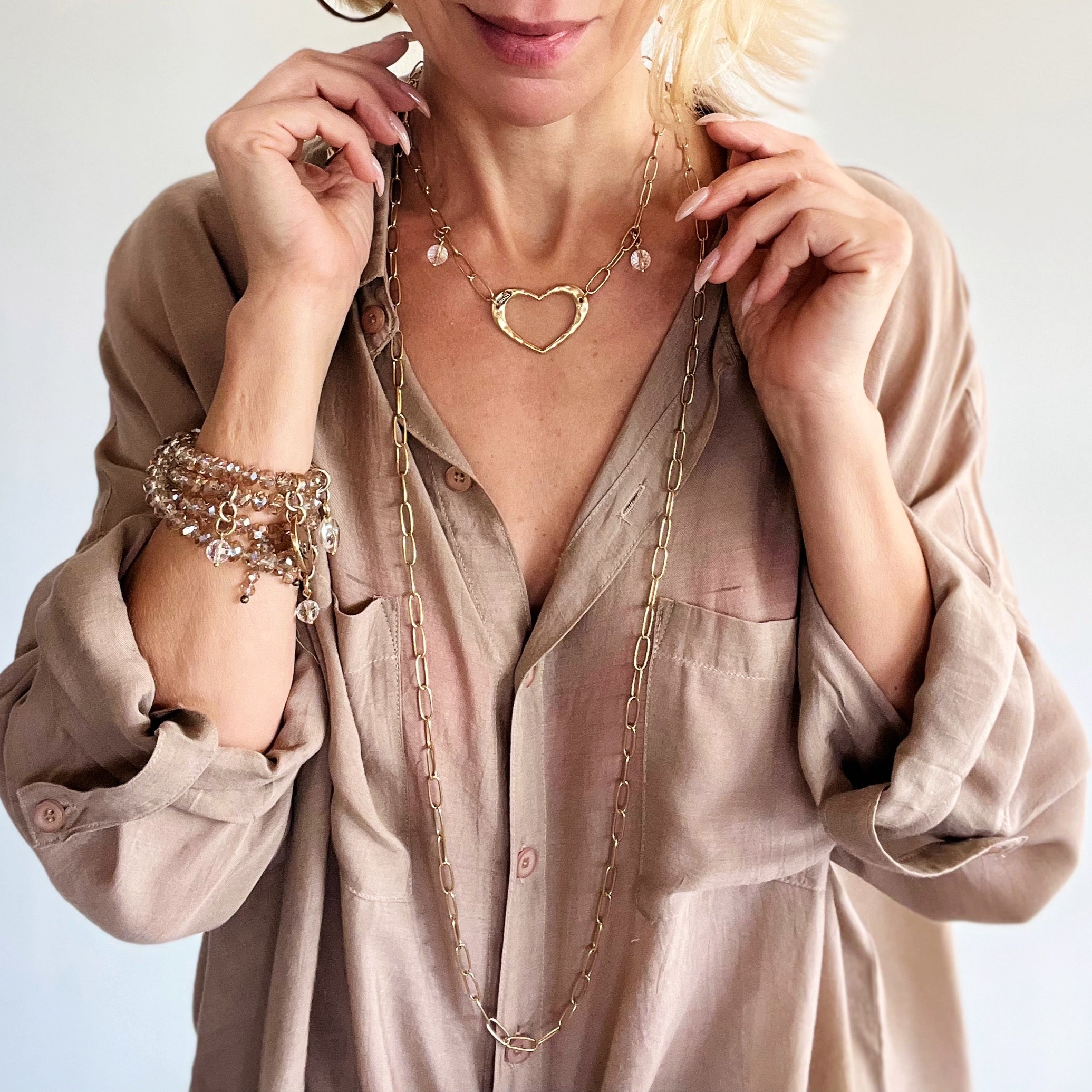 Katia Designs long chain necklace with an antique gold open heart pendant, elegant and stylish jewelry for women.
