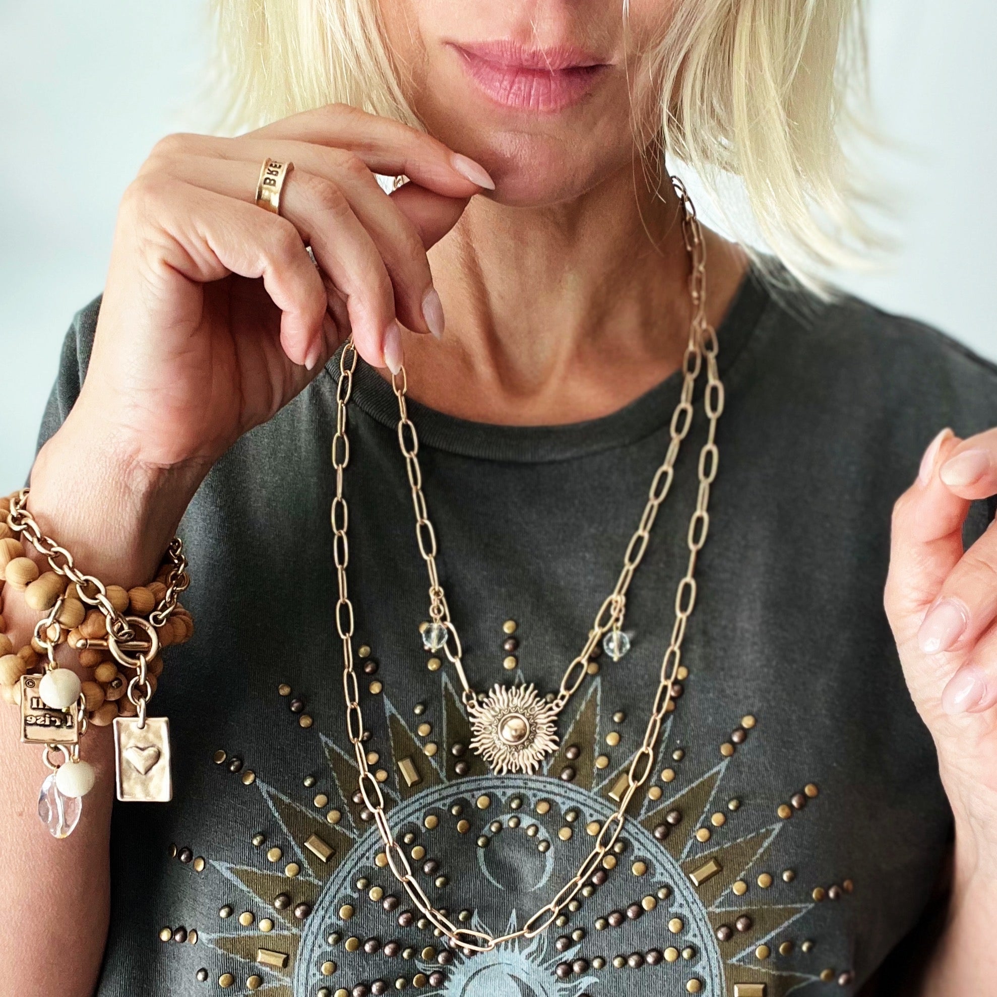 Katia Designs starburst long chain necklace in antique gold, featuring a unique imperfect starburst pendant.
