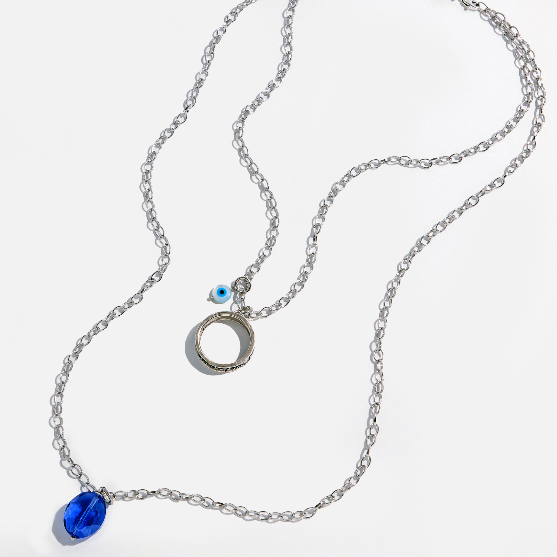 Katia Designs original antique gold necklace featuring a clear AB crystal with an "I Welcome Miracles" ring pendant.