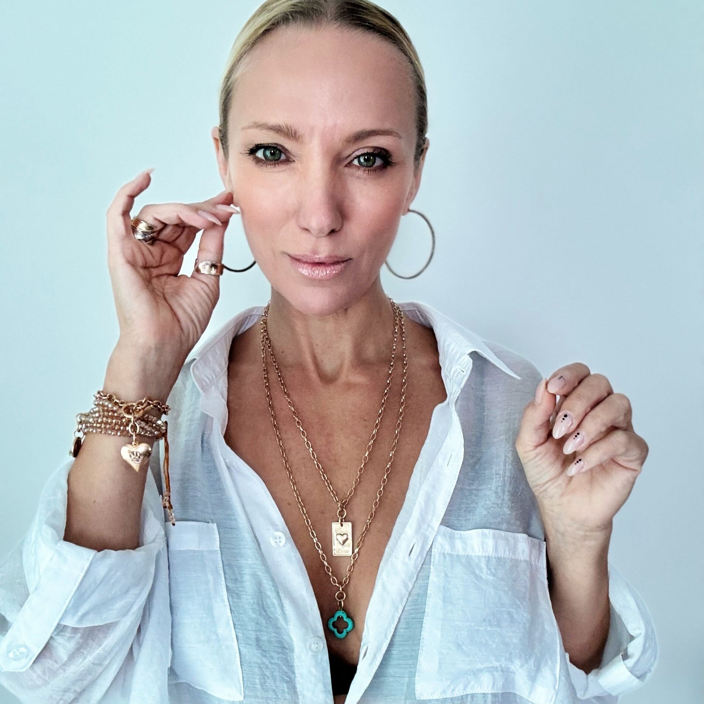 Katia Designs original lite necklace in antique gold with a clover and engraved "Remember Who the F*ck You Are" pendant.