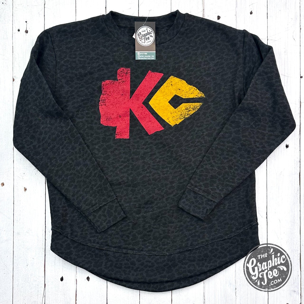 Black leopard women's curved hem crewneck sweatshirt by The Graphic Tee featuring a stylish arrowhead graphic print.
