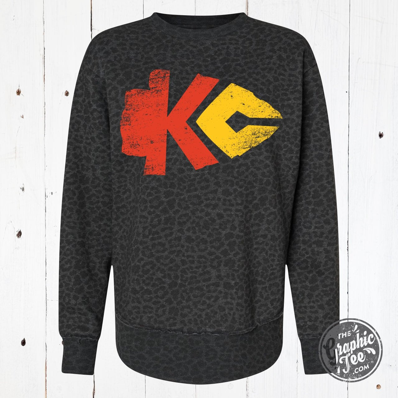 Black leopard print women's crewneck sweatshirt with curved hem from KC Arrowhead by The Graphic Tee, featuring a relaxed fit and graphic design.