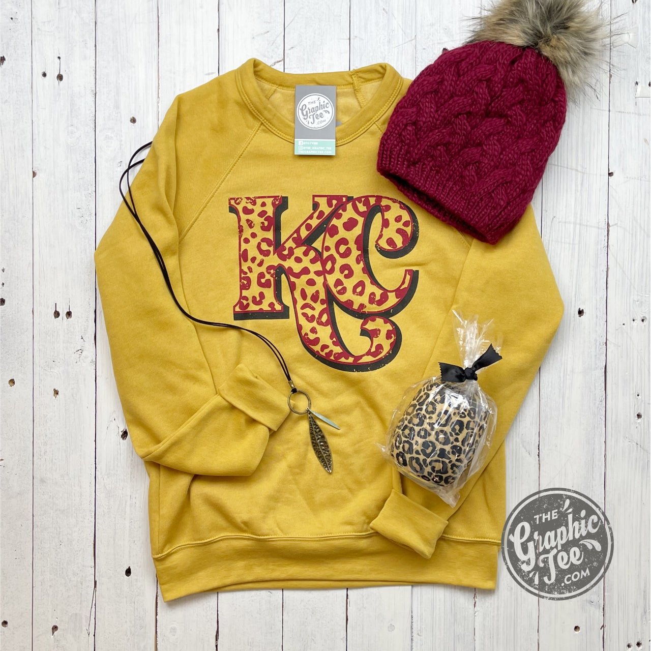 KC Cheetah Heather Mustard Sponge Fleece Crew Neck Sweatshirt from The Graphic Tee, showing the cozy fleece fabric and cheetah graphic design.