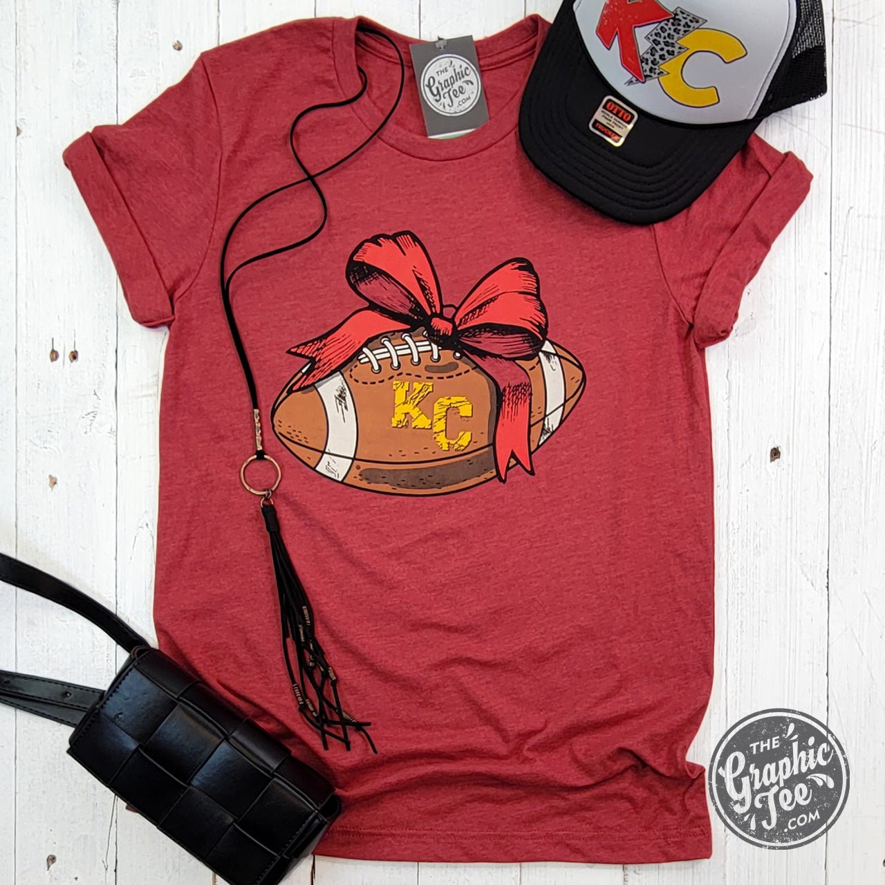 KC Football Bow Heather Cardinal short sleeve crewneck tee by The Graphic Tee, featuring a football graphic on a heathered red fabric.