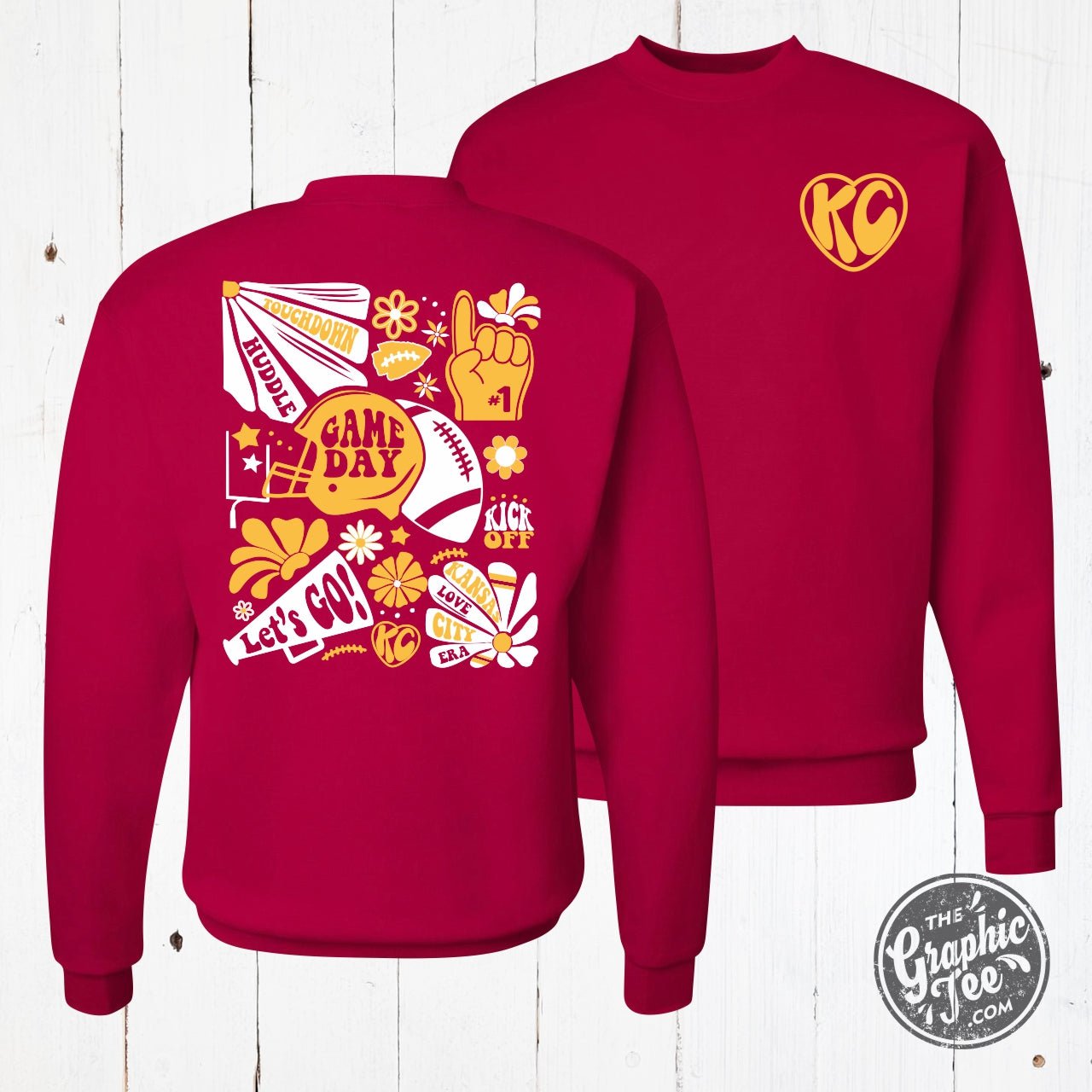 Deep red KC Groovy crewneck sweatshirt with graphic design, made by The Graphic Tee, shown on a plain background.