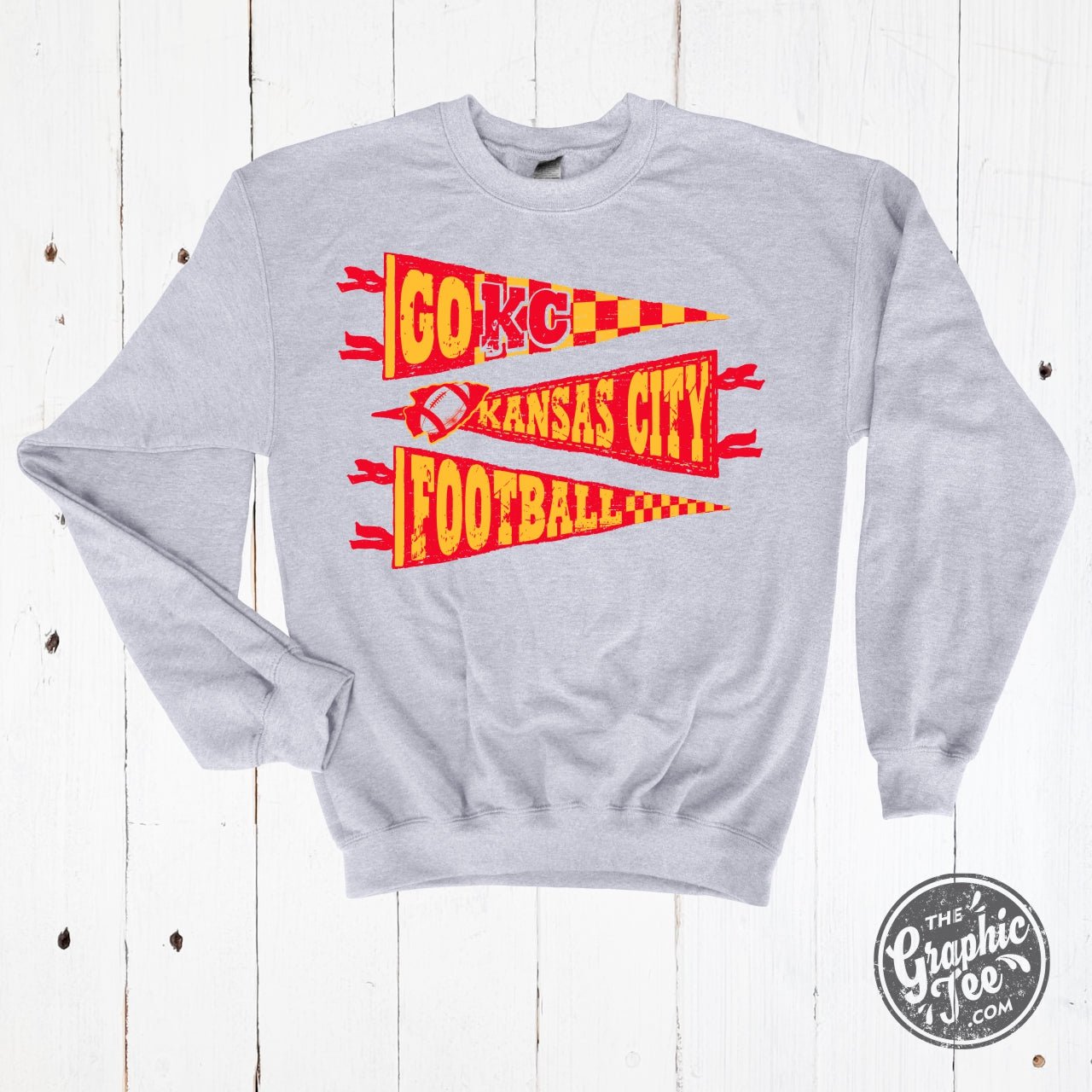 Adult ash crewneck sweatshirt featuring KC Pennants graphic design by The Graphic Tee, casual and comfortable for everyday wear.