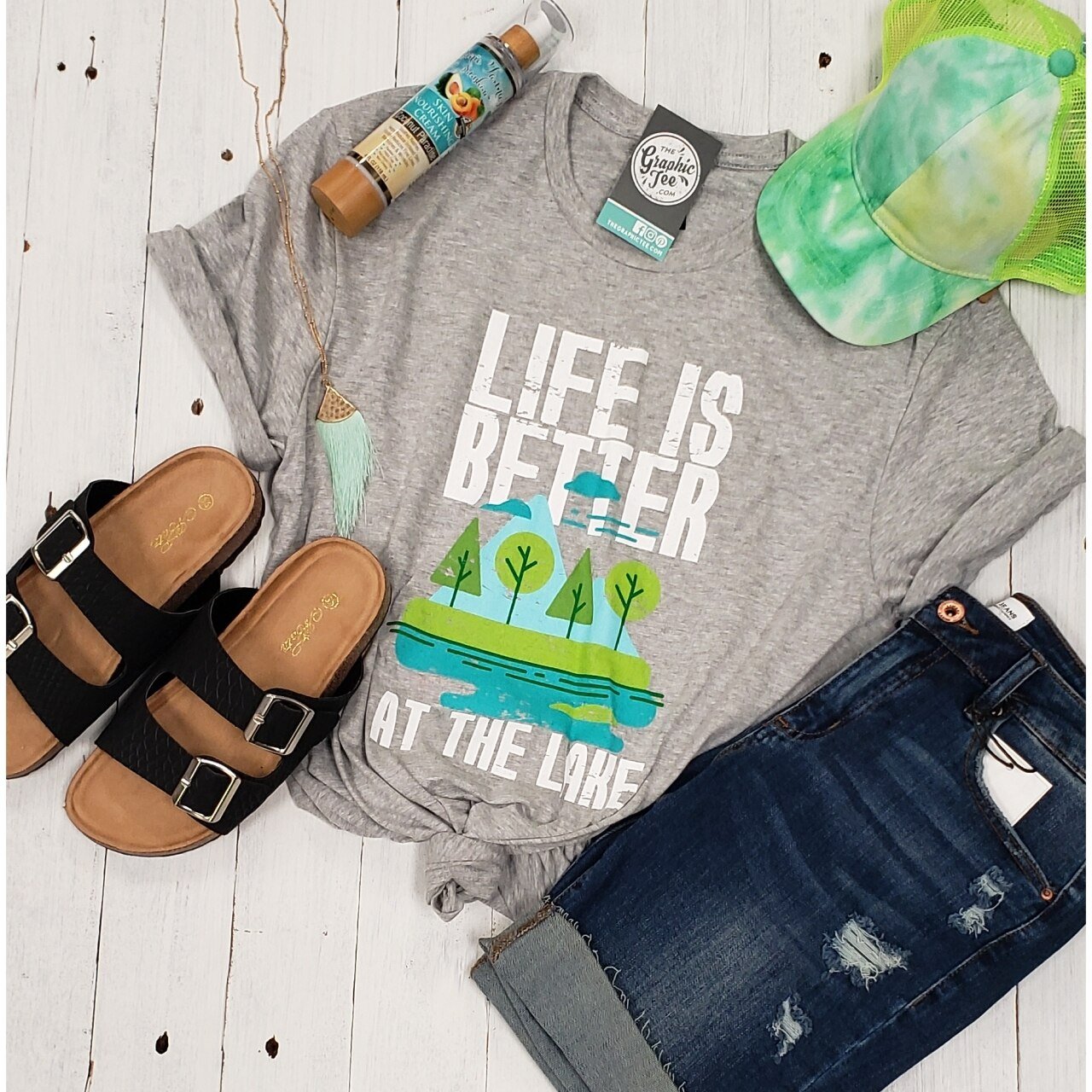 Short sleeve graphic tee by The Graphic Tee with "Life is Better at the Lake" design, perfect for casual lake day wear.