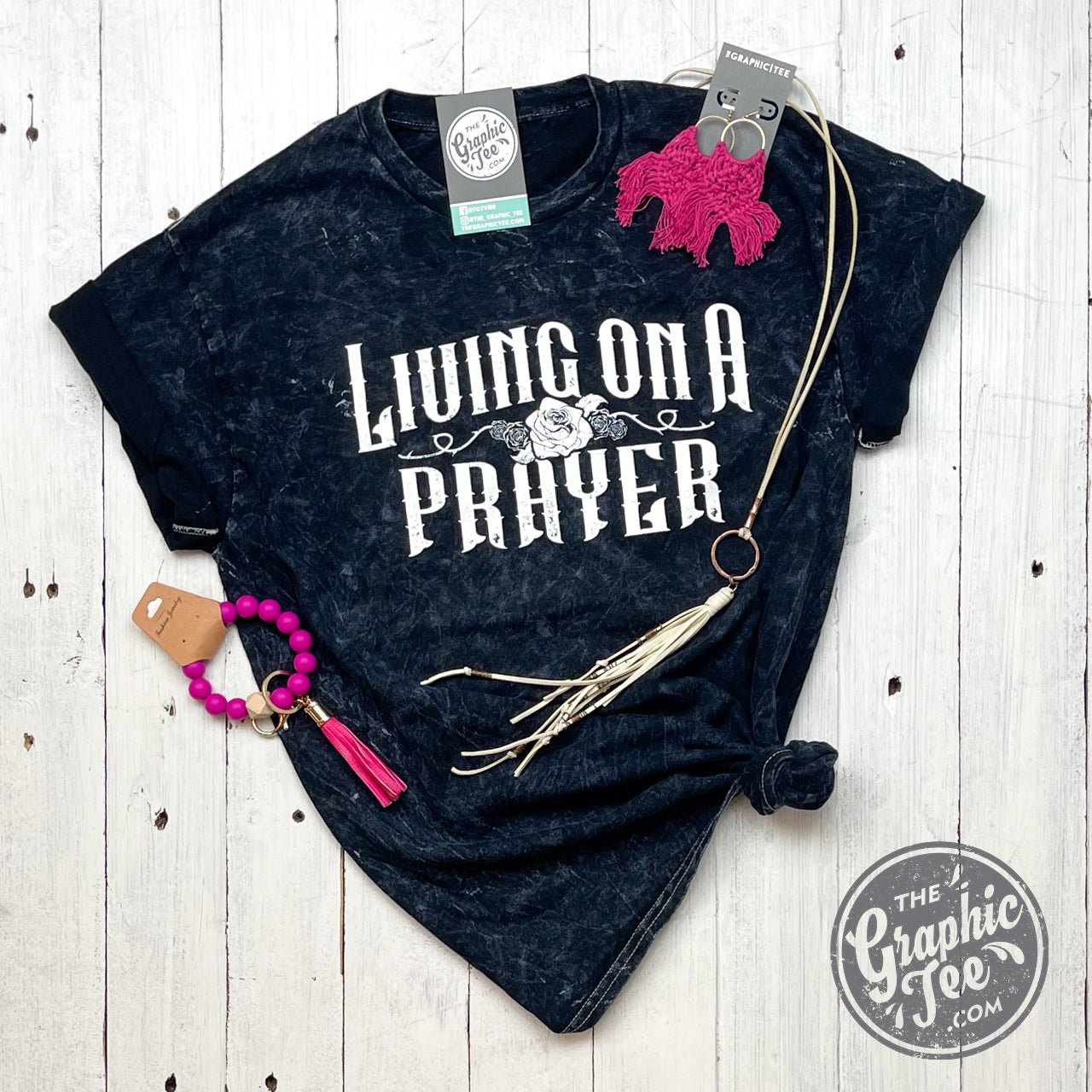 Black mineral wash crew neck short sleeve graphic tee by The Graphic Tee featuring "Living On A Prayer" design.