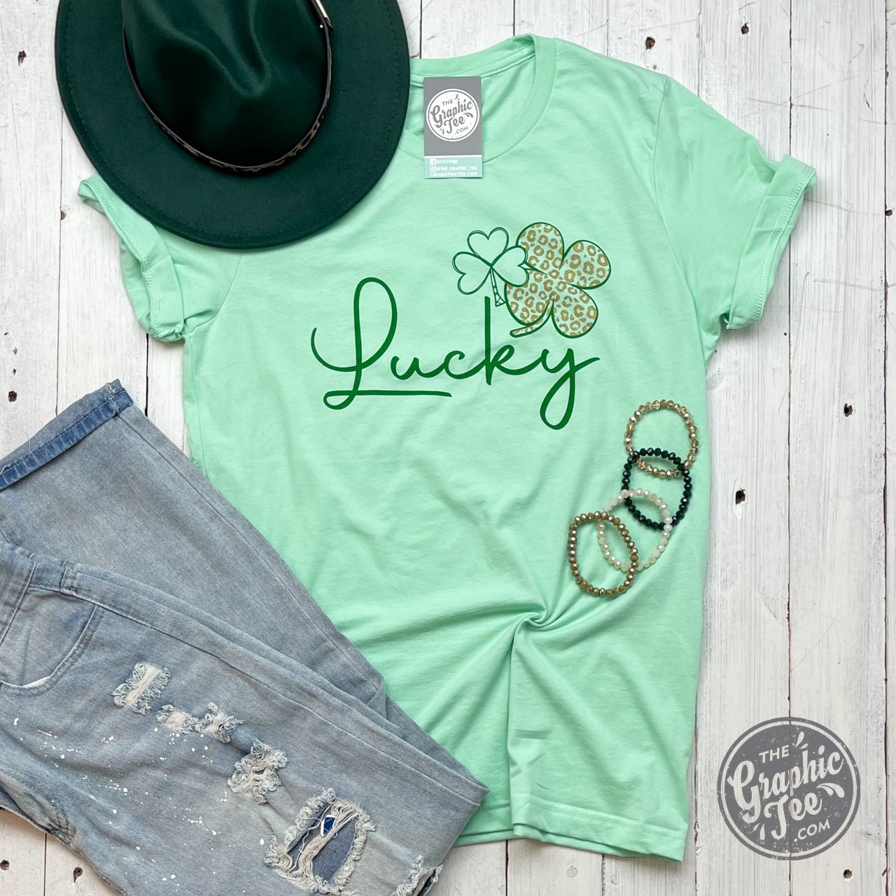 Lucky Gold Cheetah Shamrock short sleeve graphic tee by The Graphic Tee, featuring a vibrant cheetah and shamrock design.