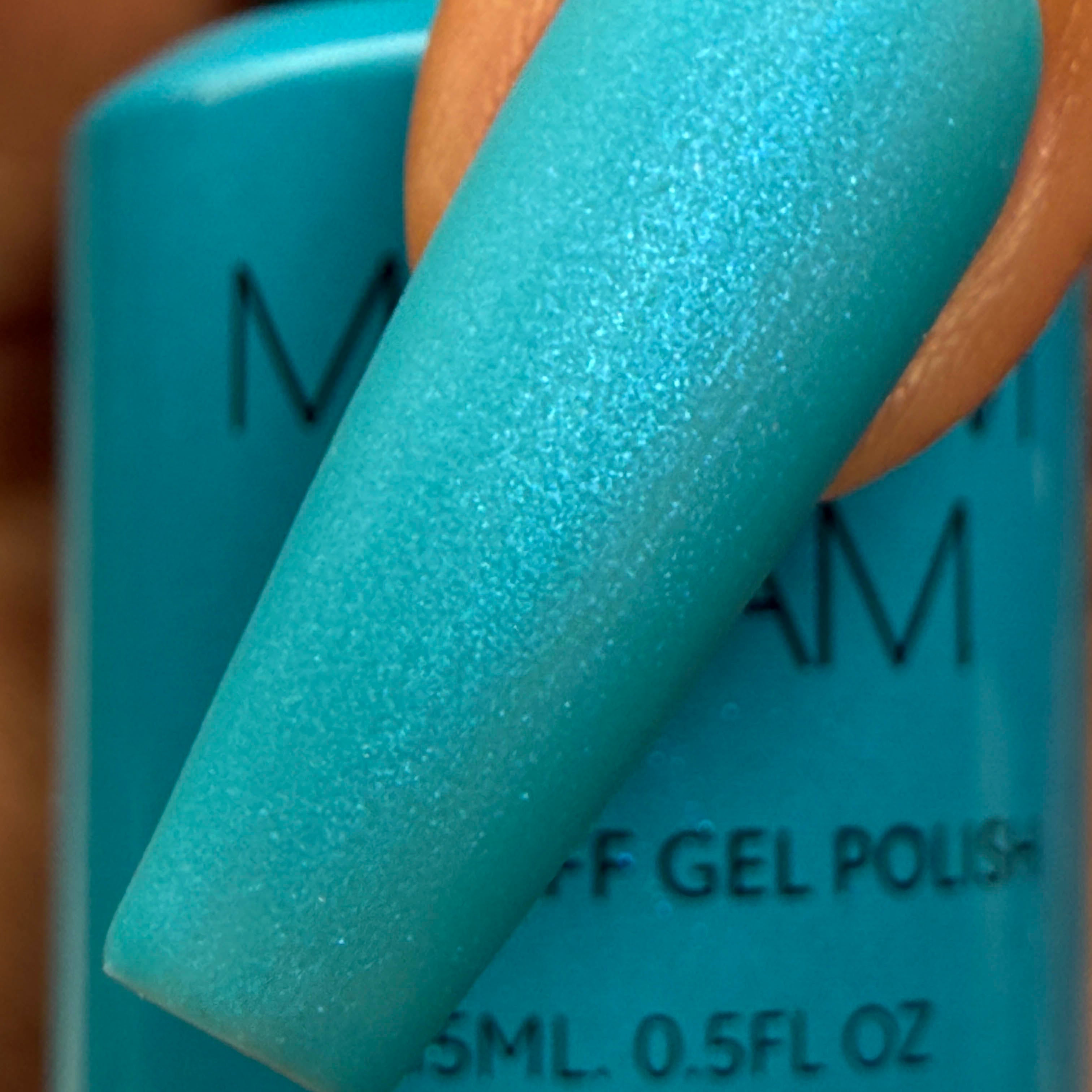 Madam Glam Aqua Shine nail polish bottle with vibrant blue color and sleek packaging displayed in the image.