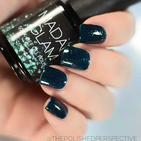 Glittery emerald nail polish by Madam Glam with shimmering green, showcasing its vibrant, sparkly finish and smooth application.