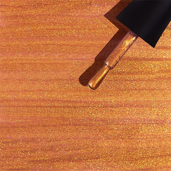 Madam Glam Golden Leaves nail polish with shimmering gold leaf design on a clear background.