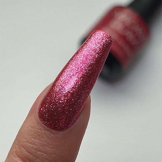 Madam Glam Heart Glow nail polish with a shimmering pink heart-shaped design on a clear base.