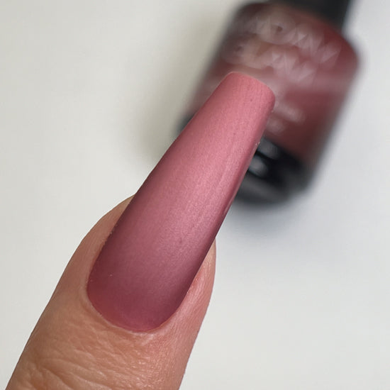 Madam Glam Sweet Merlot nail polish bottle with deep red color and sleek packaging, showcasing the vibrant shade of the product.