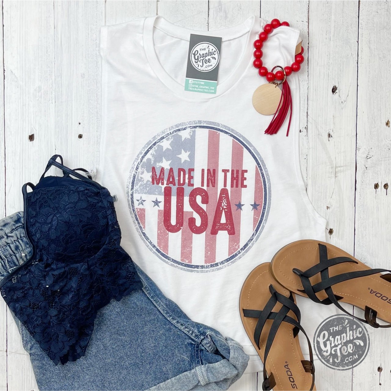 Made in the USA ladies muscle tank crop top by The Graphic Tee, featuring a stylish graphic design on a sleeveless crop top.