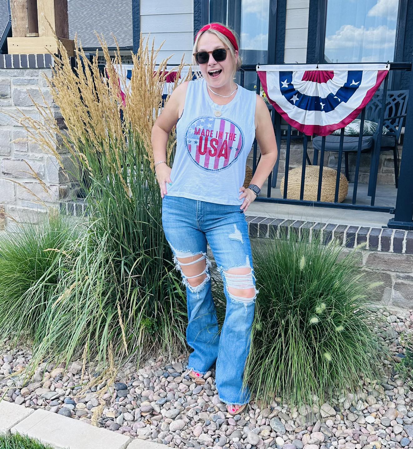 Made in the USA ladies muscle tank crop top with graphic design, from The Graphic Tee, shown on a model.