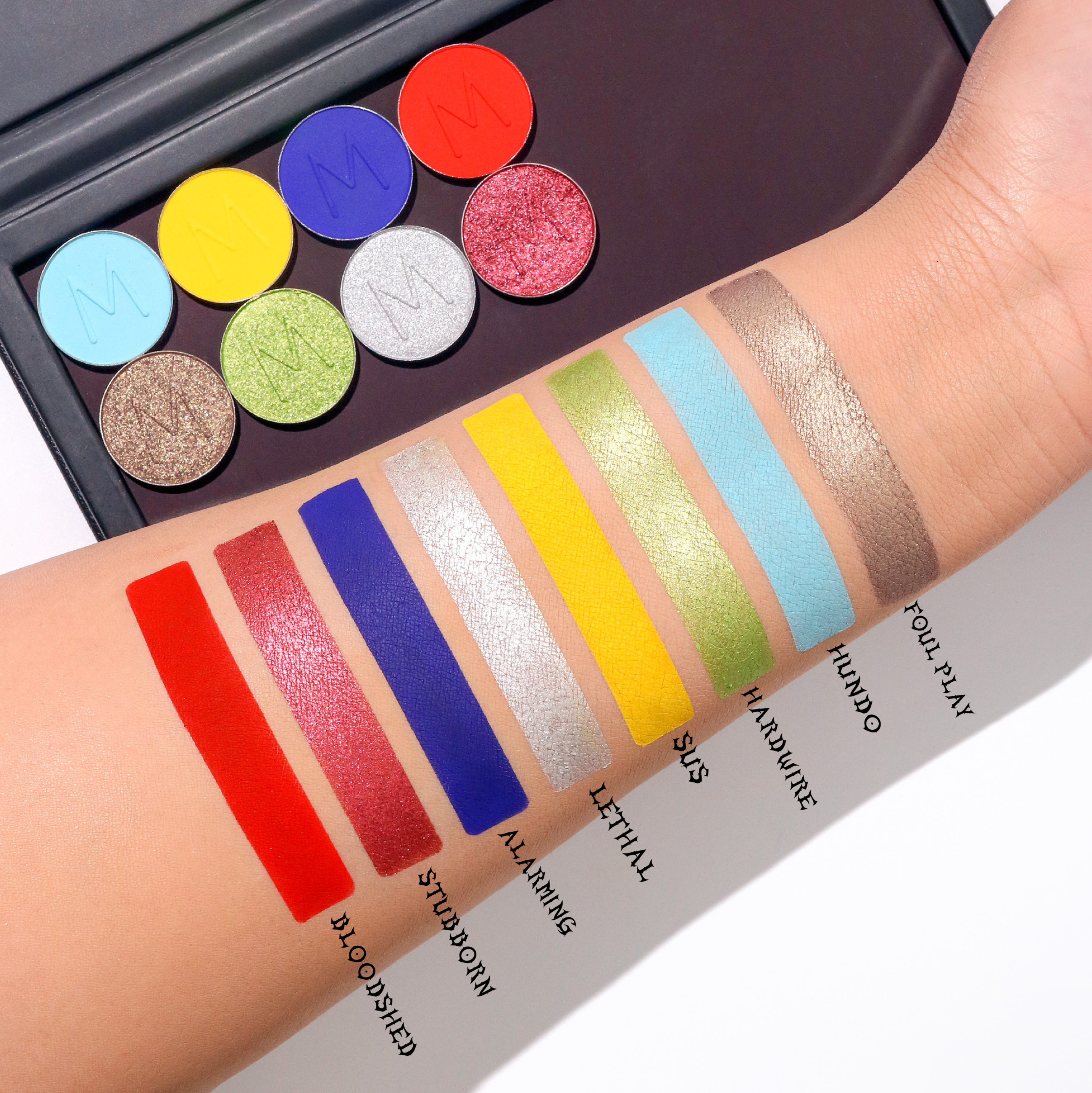 Makeup A Murder, INC Bloodshed eyeshadow lineup with multiple vibrant and matte eye shadow shades arranged in a palette.