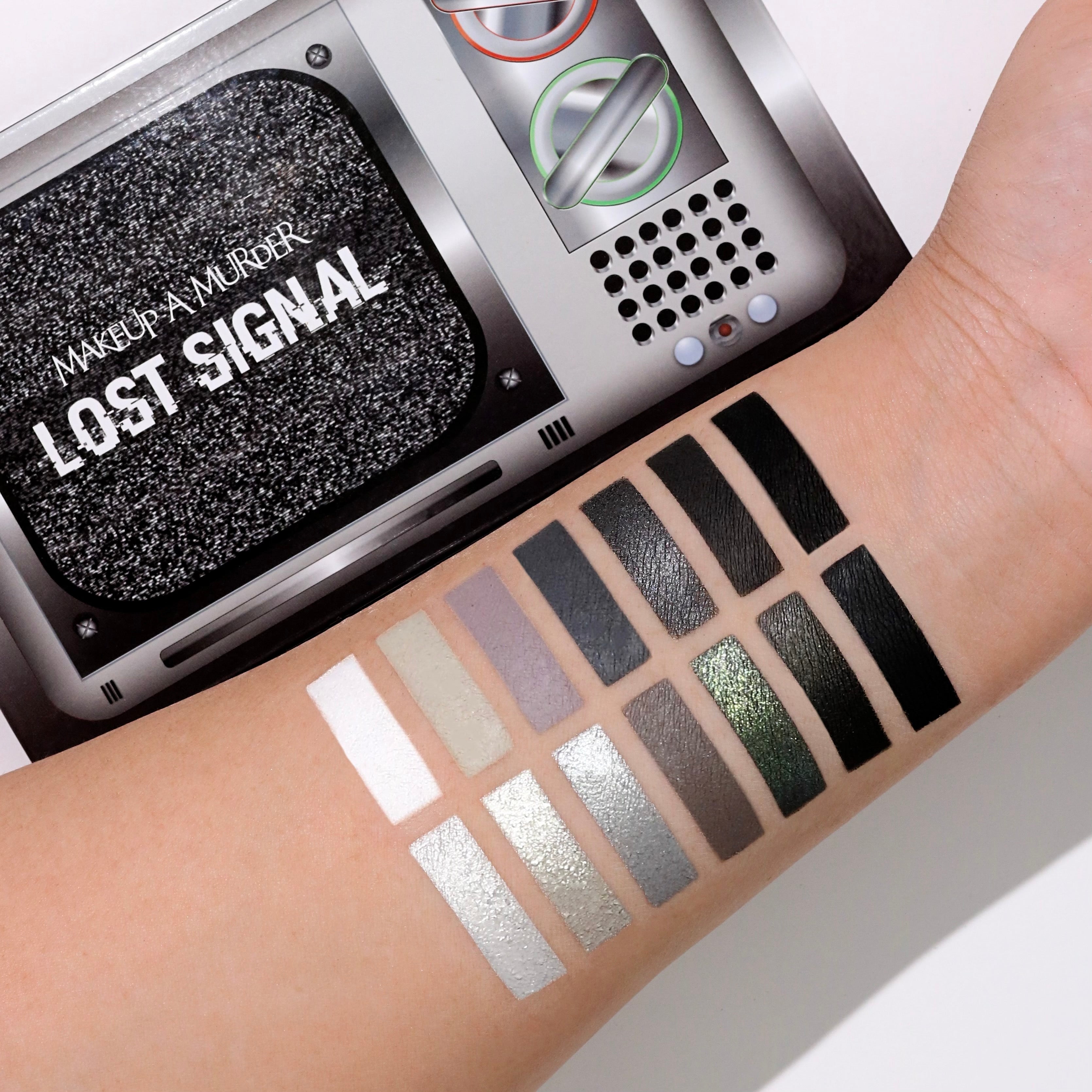 Lost Signal eyeshadow palette by Makeup A Murder, INC featuring vibrant and neutral shades in a sleek makeup palette.