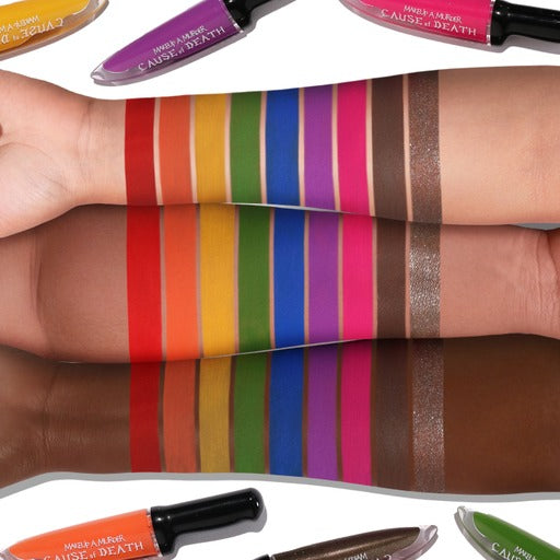 Makeup A Murder, INC rainbow liquid eyeshadow collection with vibrant shades in a red coffin-shaped palette.