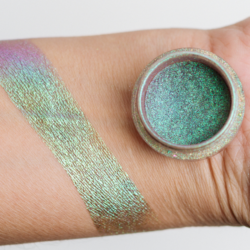 Bright Magic Pigment by NABA Cosmetics USA showing shimmering, colorful powder in a sleek container.