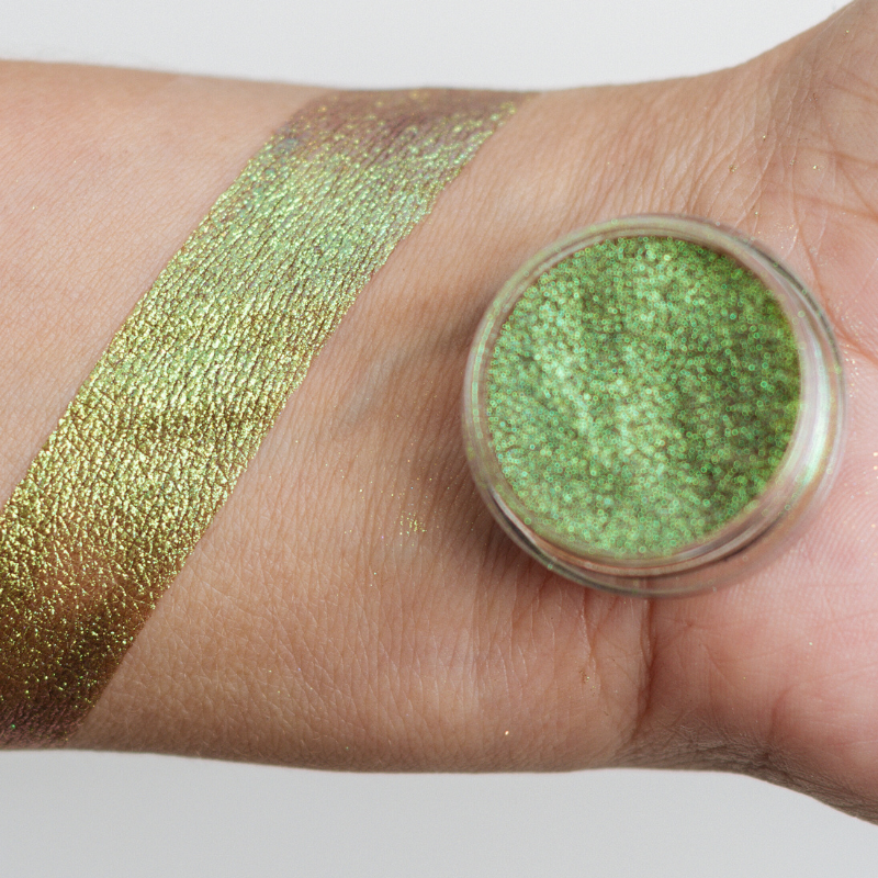 Vibrant rainbow-colored pigment by NABA Cosmetics USA in a small jar, showcasing bright, multicolored cosmetic pigment for makeup application.