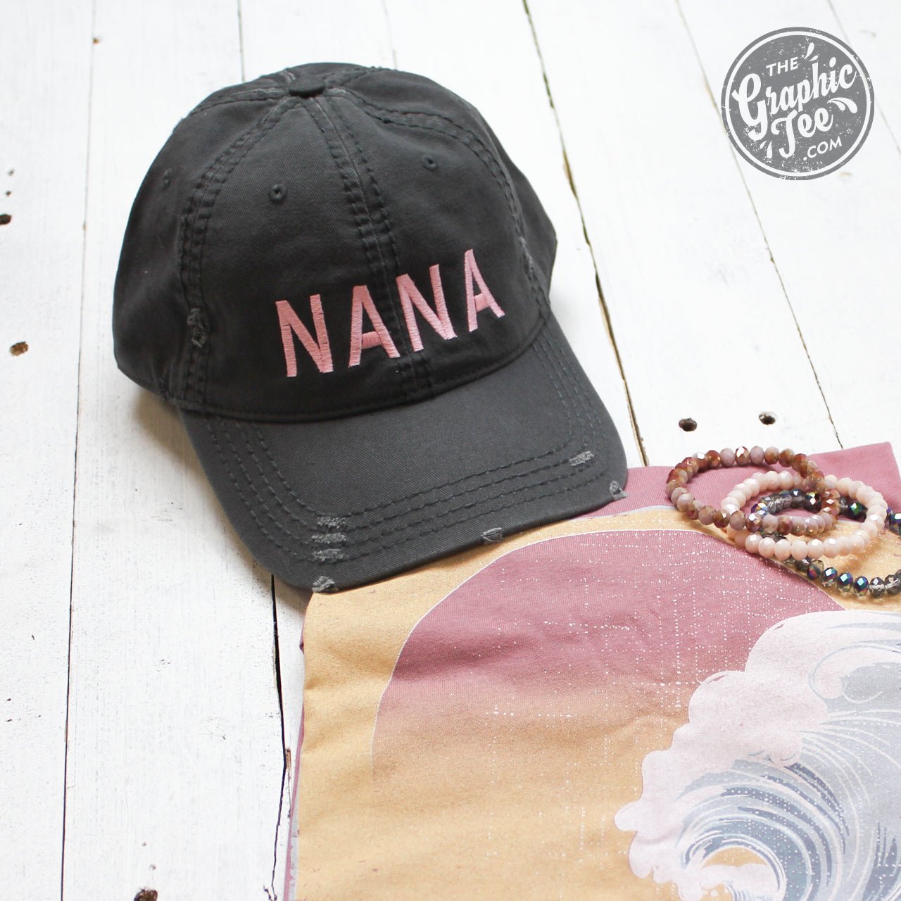 Nana charcoal distressed canvas cap by The Graphic Tee with a curved brim and casual style.