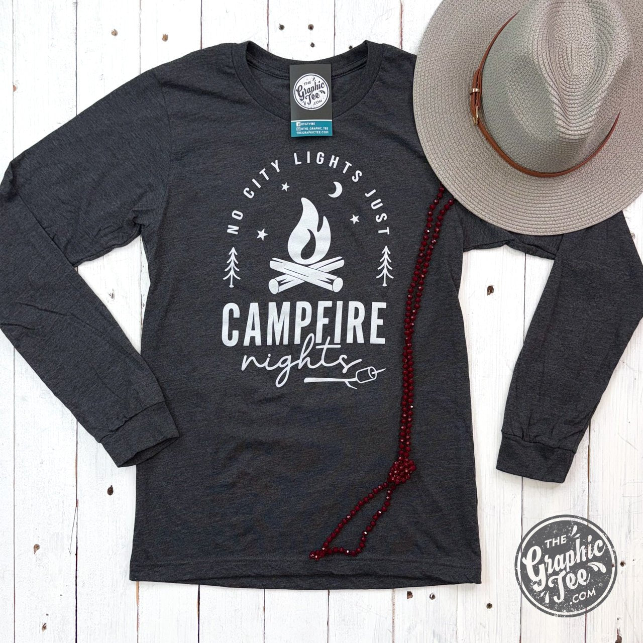 Long sleeve graphic tee by The Graphic Tee featuring "No City Lights Just Campfire Nights" design on soft fabric.