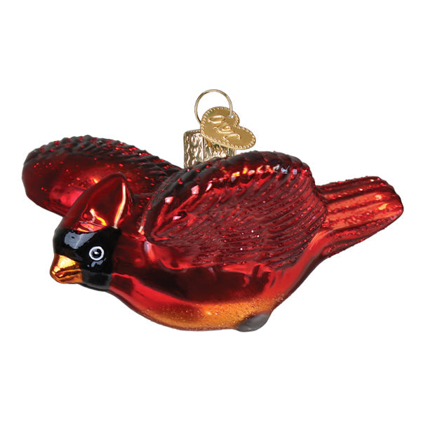 Old World Christmas Cardinal in Flight ornament featuring a vibrant red cardinal perched on a branch with detailed craftsmanship.