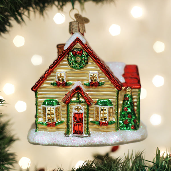 Old World Christmas Christmas Cottage Ornament featuring a detailed festive holiday scene in vibrant colors.