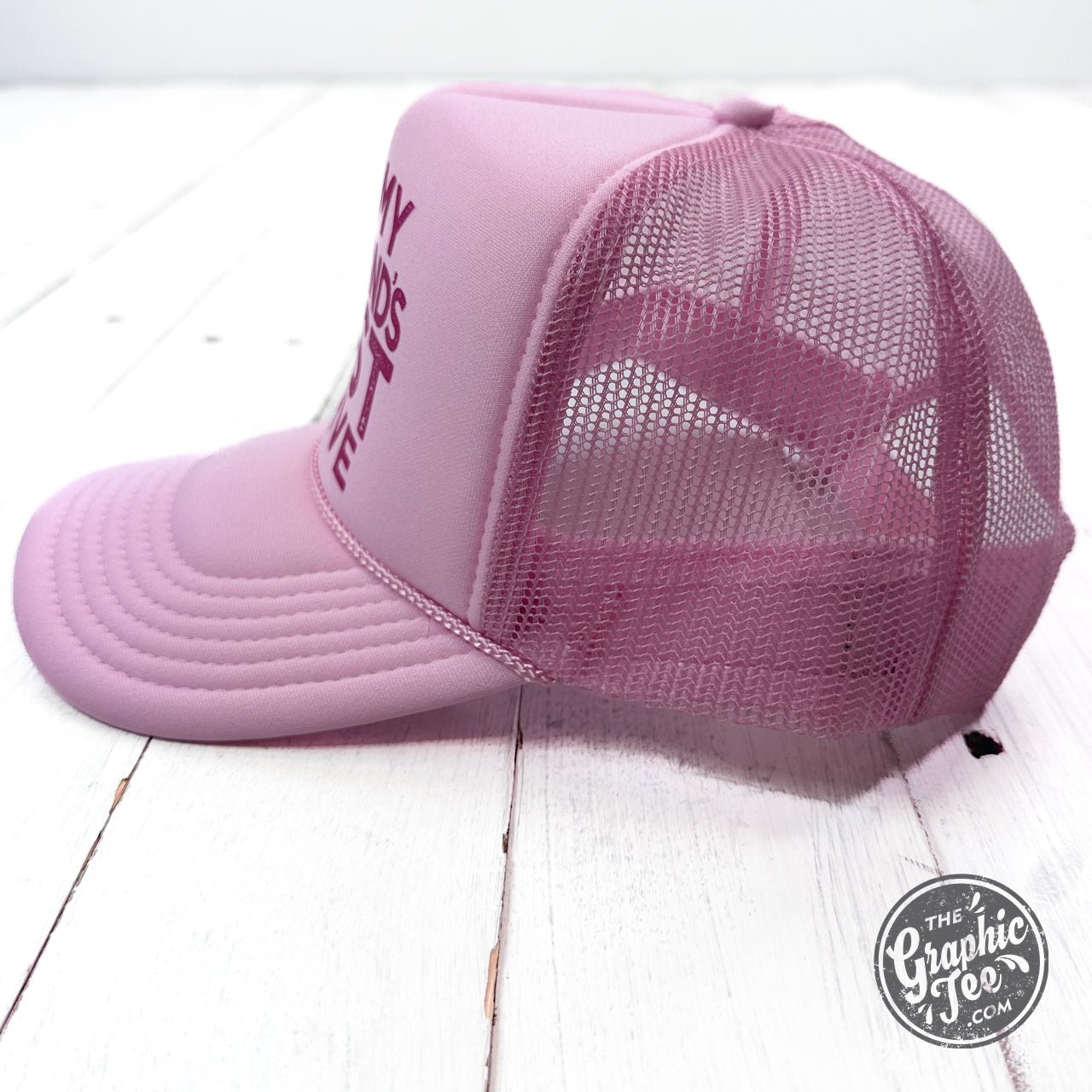Foam trucker cap with humorous "On My Husband's Last Nerve" graphic by The Graphic Tee, showing front view of the cap.