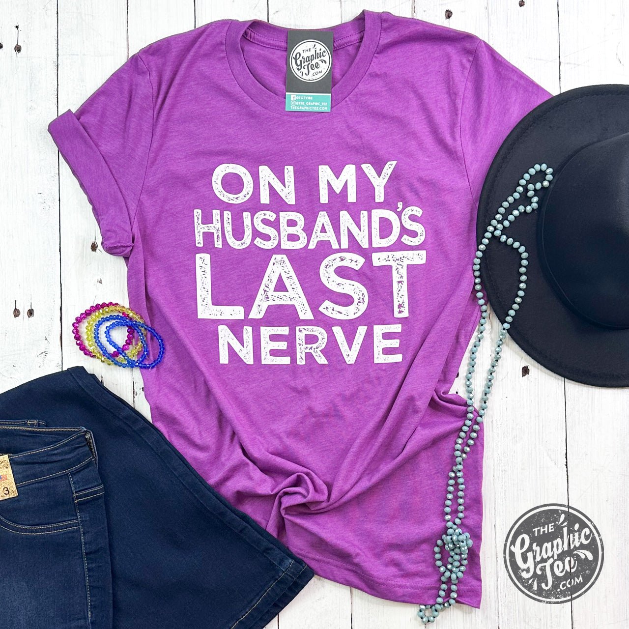 Unisex graphic T-shirt featuring humorous "On My Husband's Last Nerve" design by The Graphic Tee, casual and comfortable wear.