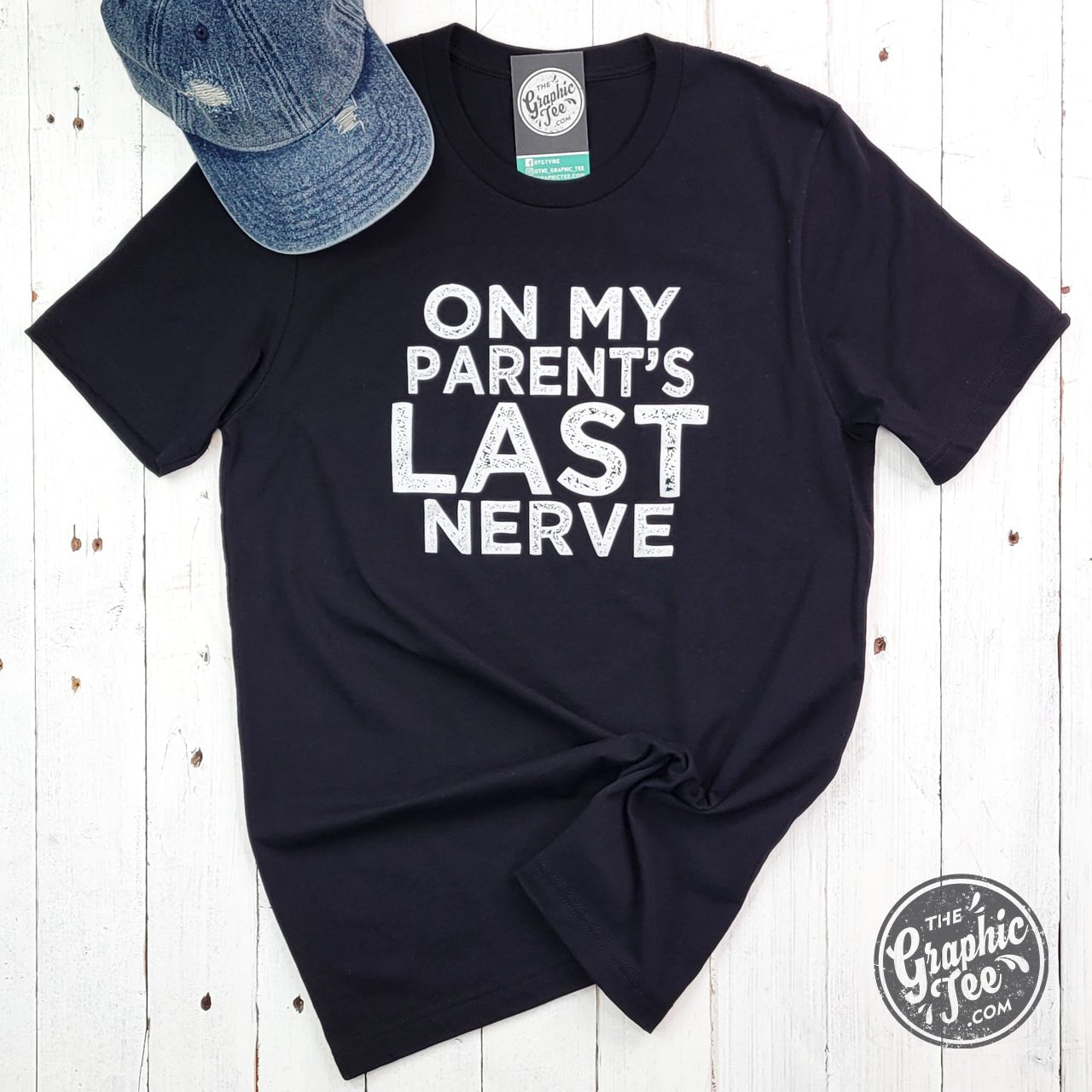 Unisex black graphic T-shirt featuring humorous "On My Parent's Last Nerve" design by The Graphic Tee.