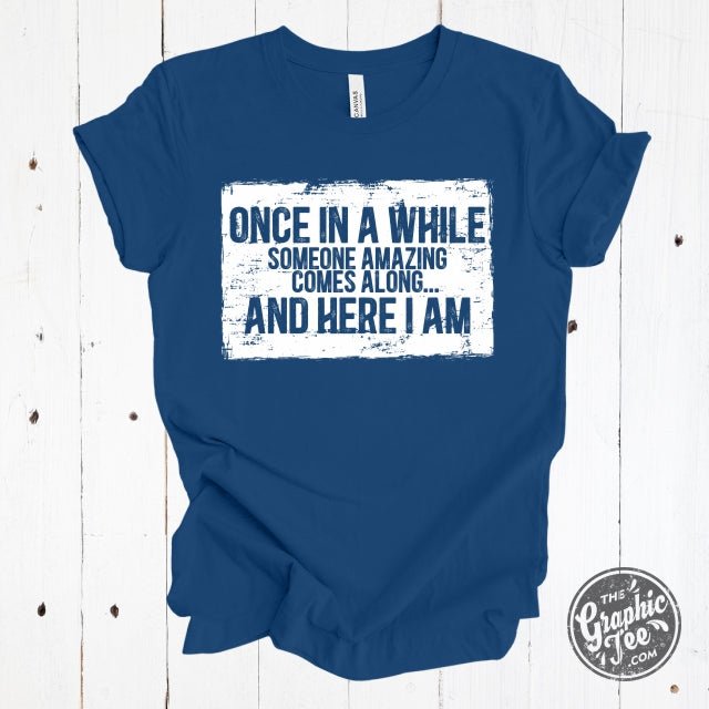 Black short sleeve graphic tee from The Graphic Tee with the phrase "Once in a while someone amazing comes along" in stylish font.