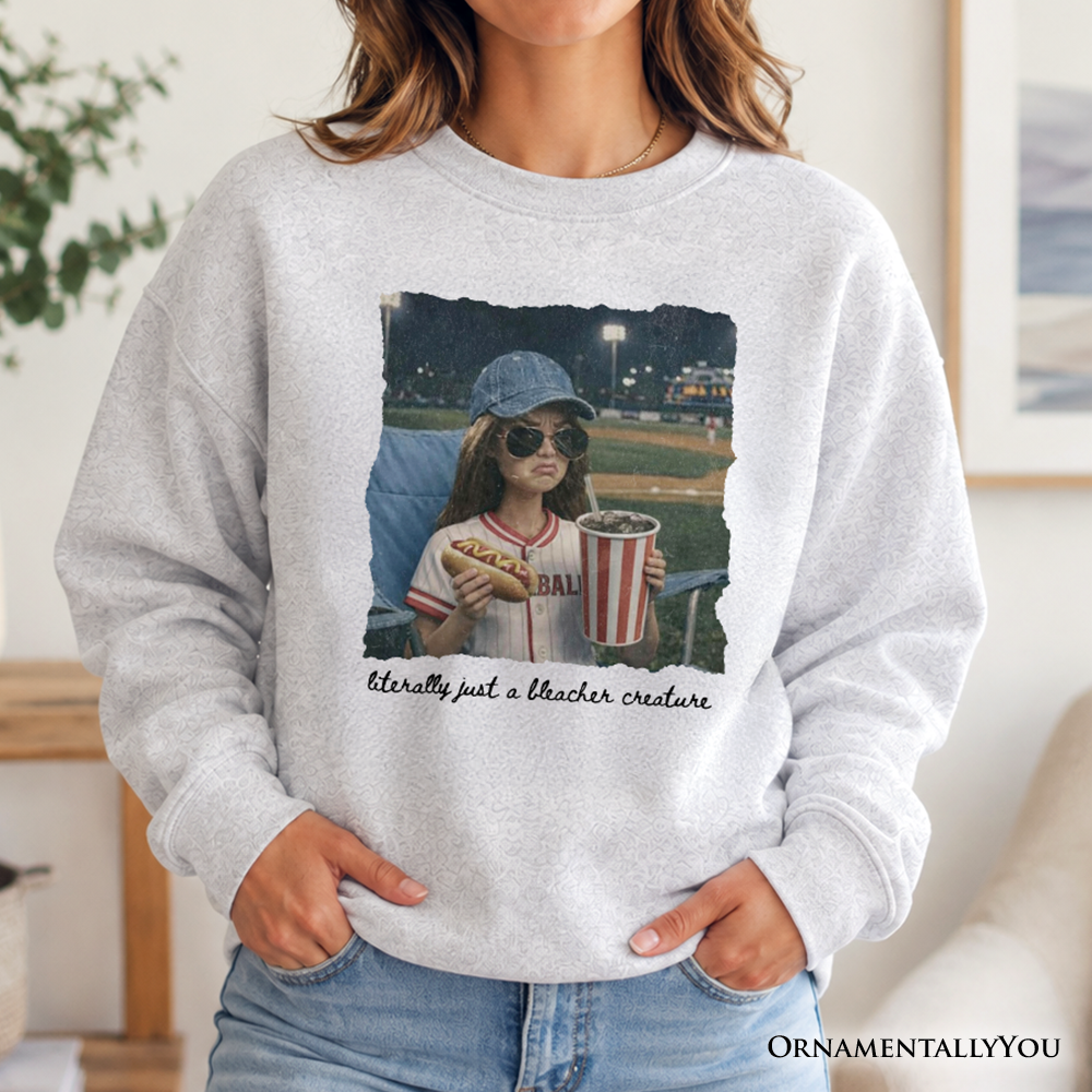 Funny doll face baseball sweatshirt for sports fan moms by OrnamentallyYou, featuring a playful doll graphic on ash-colored fabric.