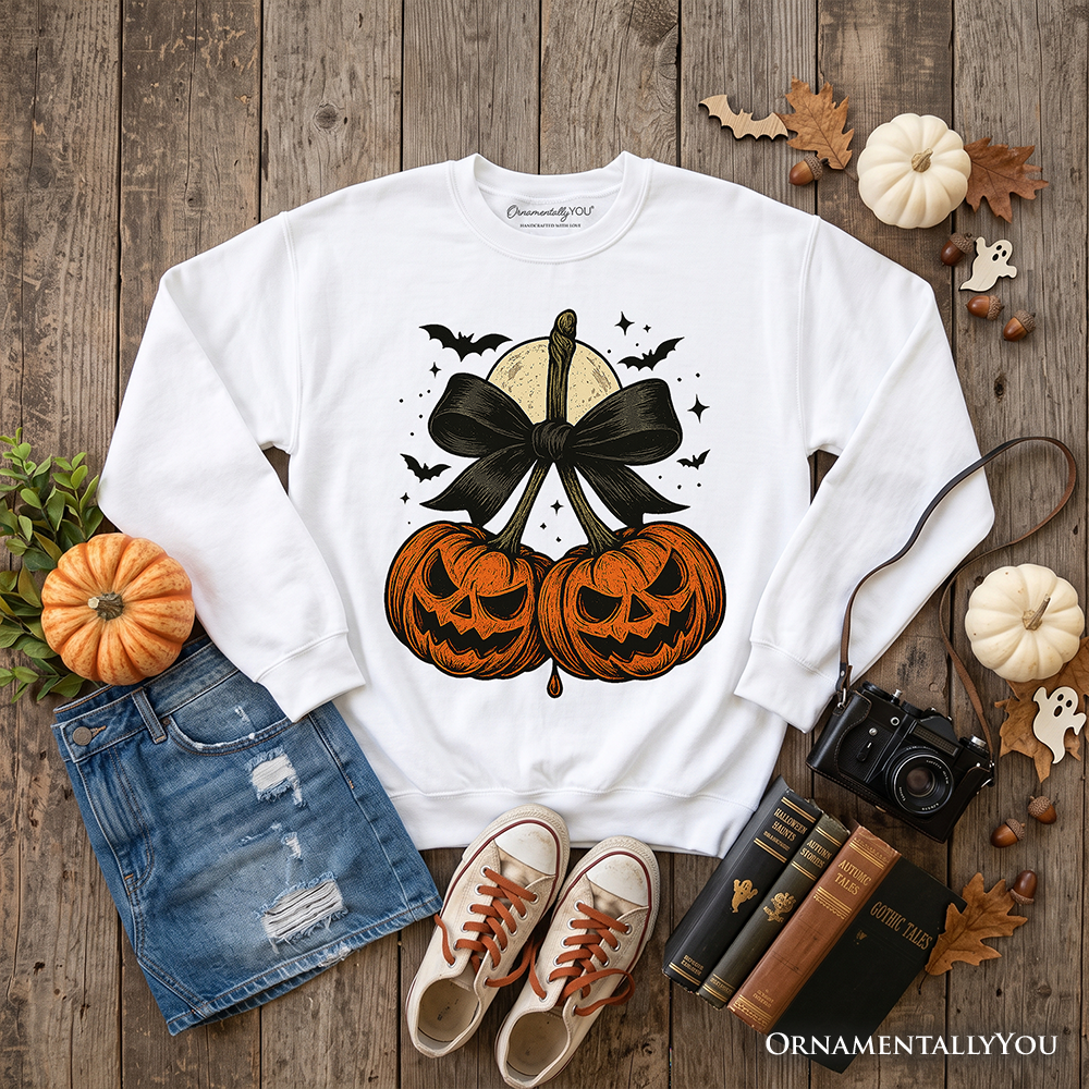 Orange and black Pumpkin Cherries Coquette Bow sweatshirt by OrnamentallyYou featuring a Halloween-inspired retro fall design for girls.