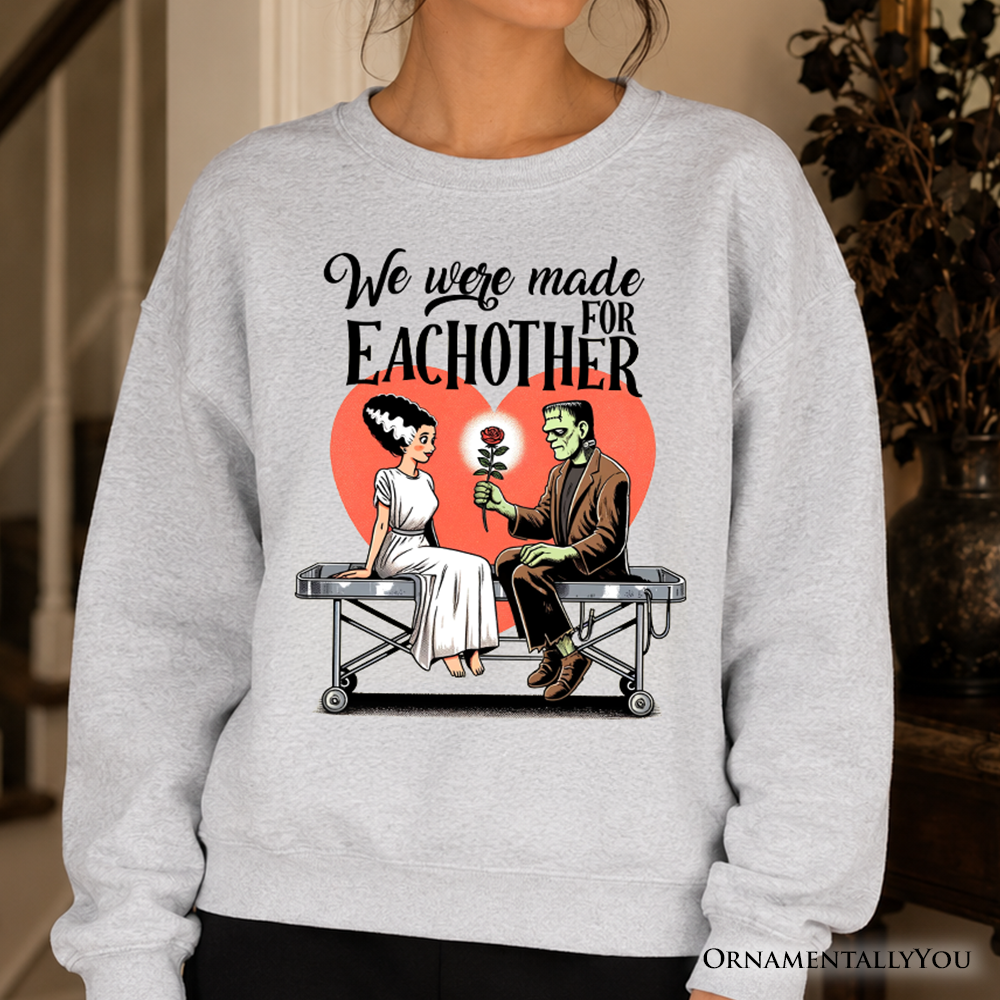 Romantic Frankenstein and Bride sweatshirt by OrnamentallyYou, featuring spooky couple design on cozy ash-colored sweatshirt.