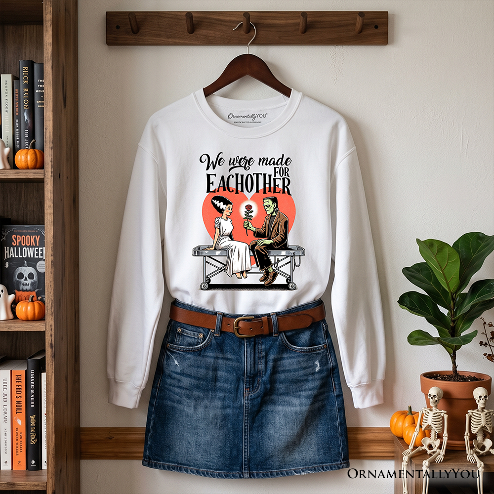Romantic Frankenstein and Bride sweatshirt from OrnamentallyYou, spookily designed for couples, featuring Halloween-themed cartoon characters.