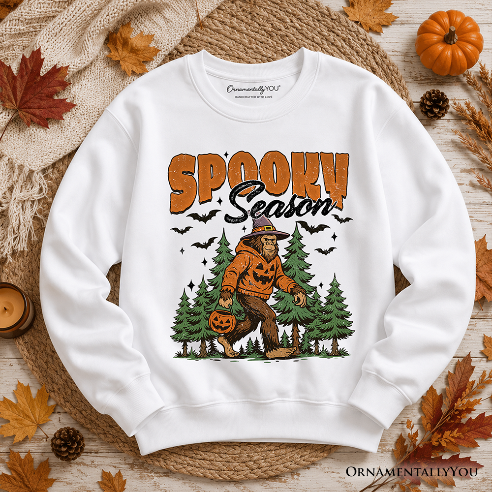 Orange Halloween Bigfoot sweatshirt featuring spooky Sasquatch and pumpkin design, by OrnamentallyYou.