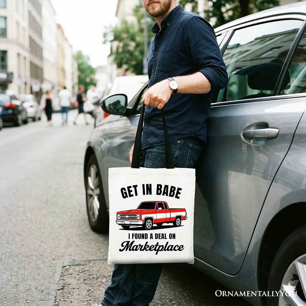 White tote bag by OrnamentallyYou featuring a humorous red truck design with "I Found A Deal On Marketplace" text, perfect for shoppers.