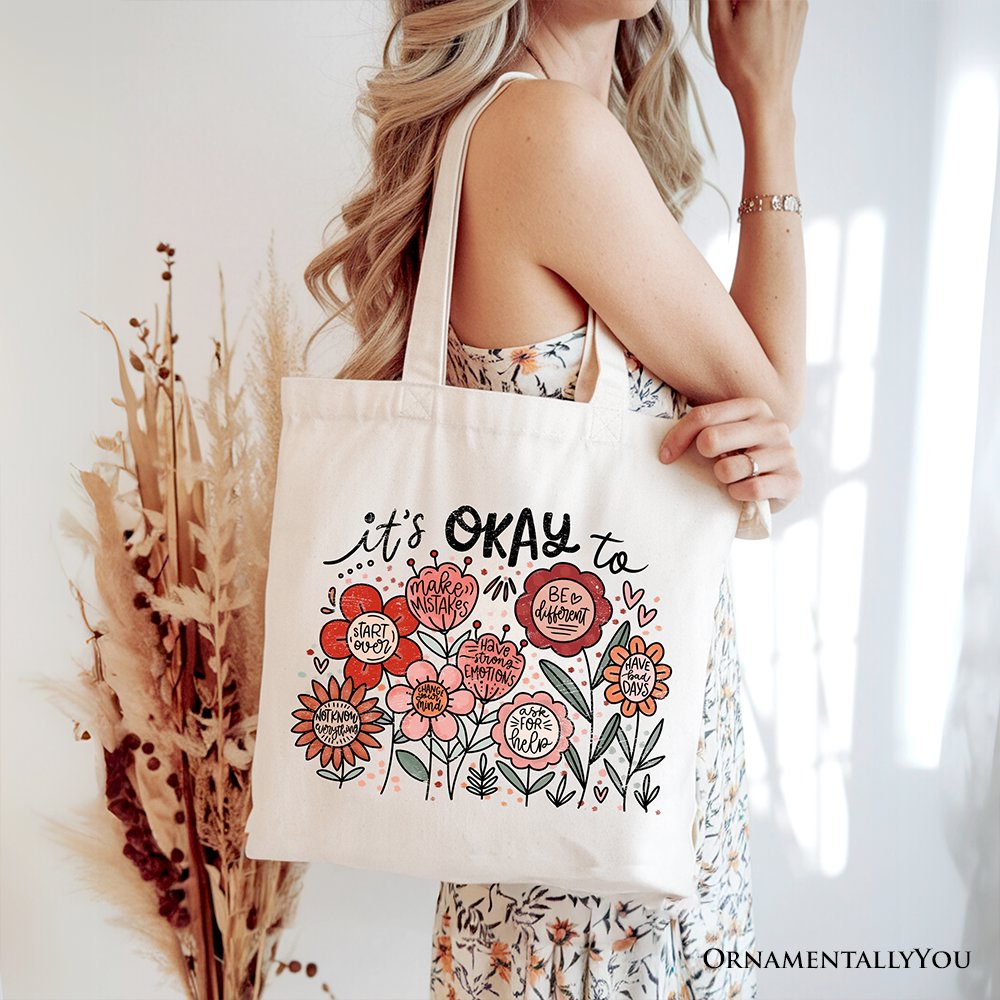 White canvas tote bag with "It's Okay" floral affirmation design, featuring boho style, by OrnamentallyYou.