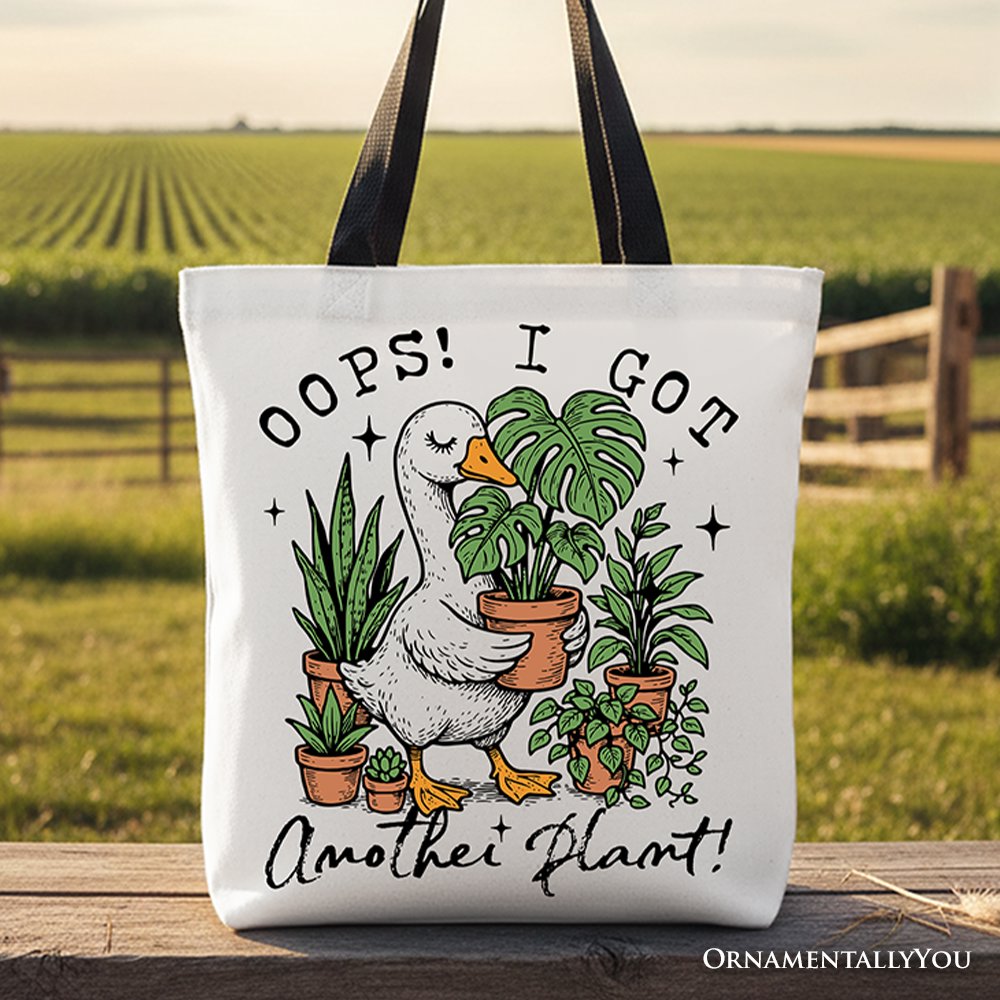 White canvas tote bag featuring humorous "Oops I Got Another Plant Goose" design, perfect for plant lovers and gardening humor fans.