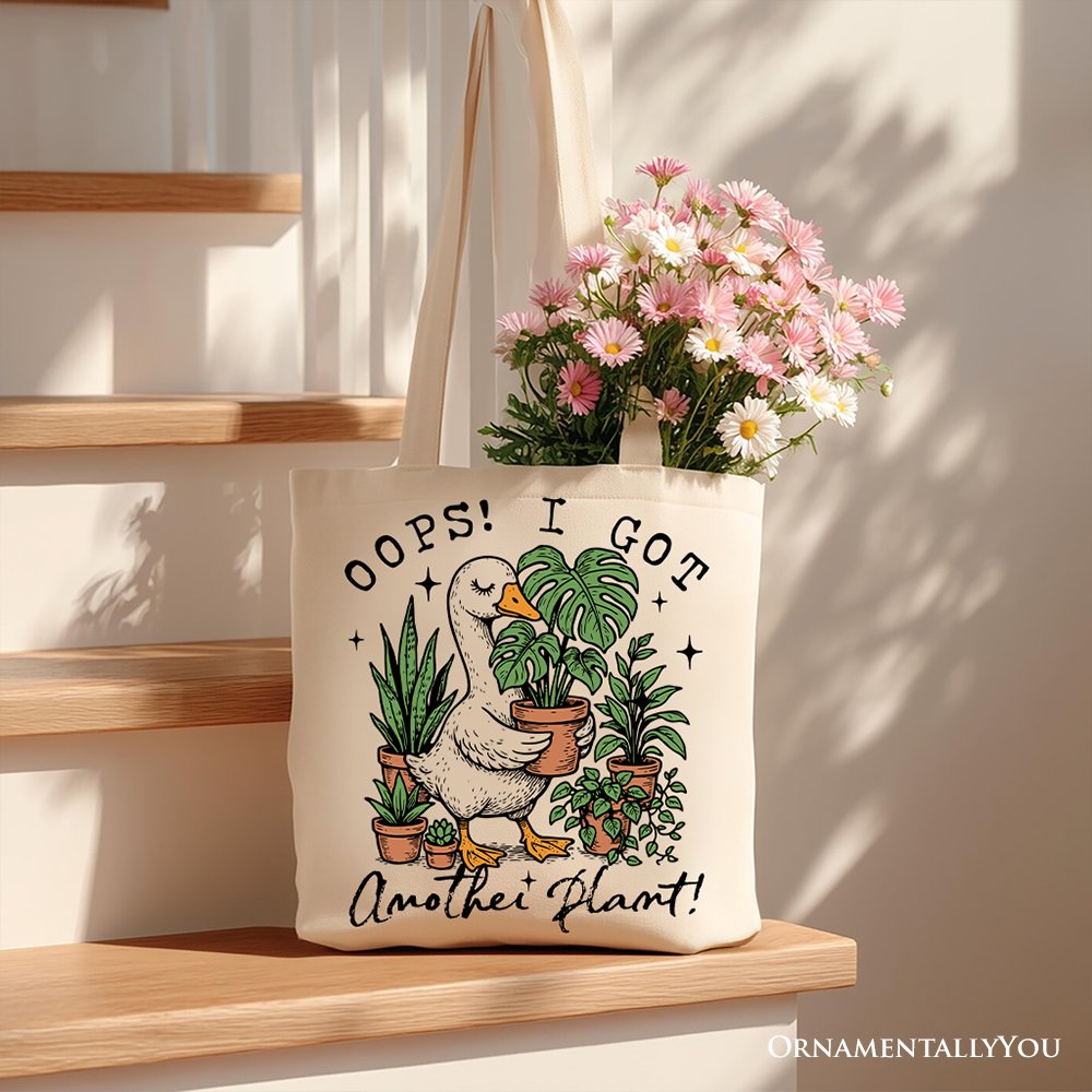 White canvas tote bag featuring humorous "Oops I Got Another Plant Goose" design, perfect for gardening humor fans.