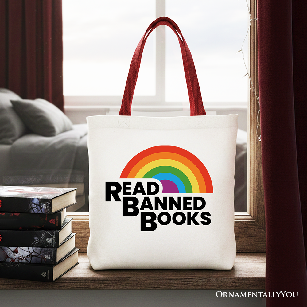 White canvas tote bag by OrnamentallyYou featuring a rainbow design and "Read Banned Books" message, perfect for book lovers.