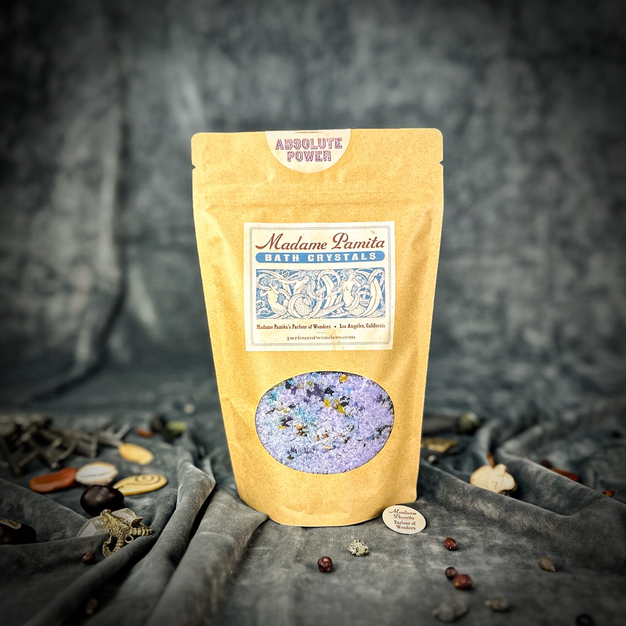 Small jar of Parlour of Wonders Absolute Power Bath Crystals with colorful crystals and a relaxing spa setting.