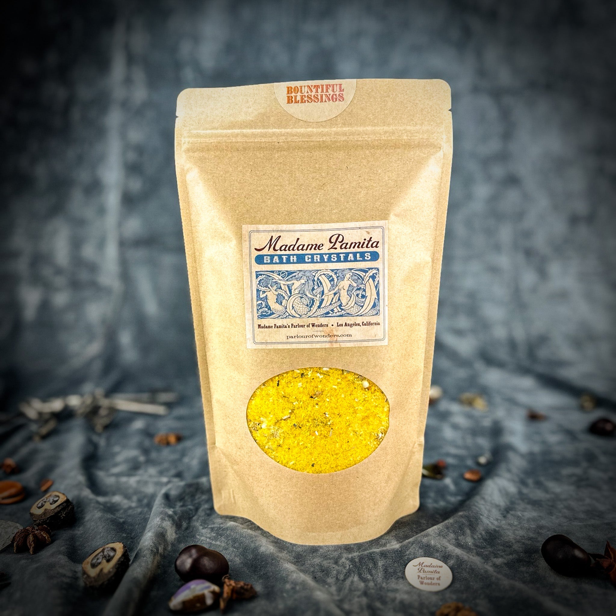 Small jar of Parlour of Wonders Bountiful Blessings Bath Crystals with colorful crystals and a decorative label.