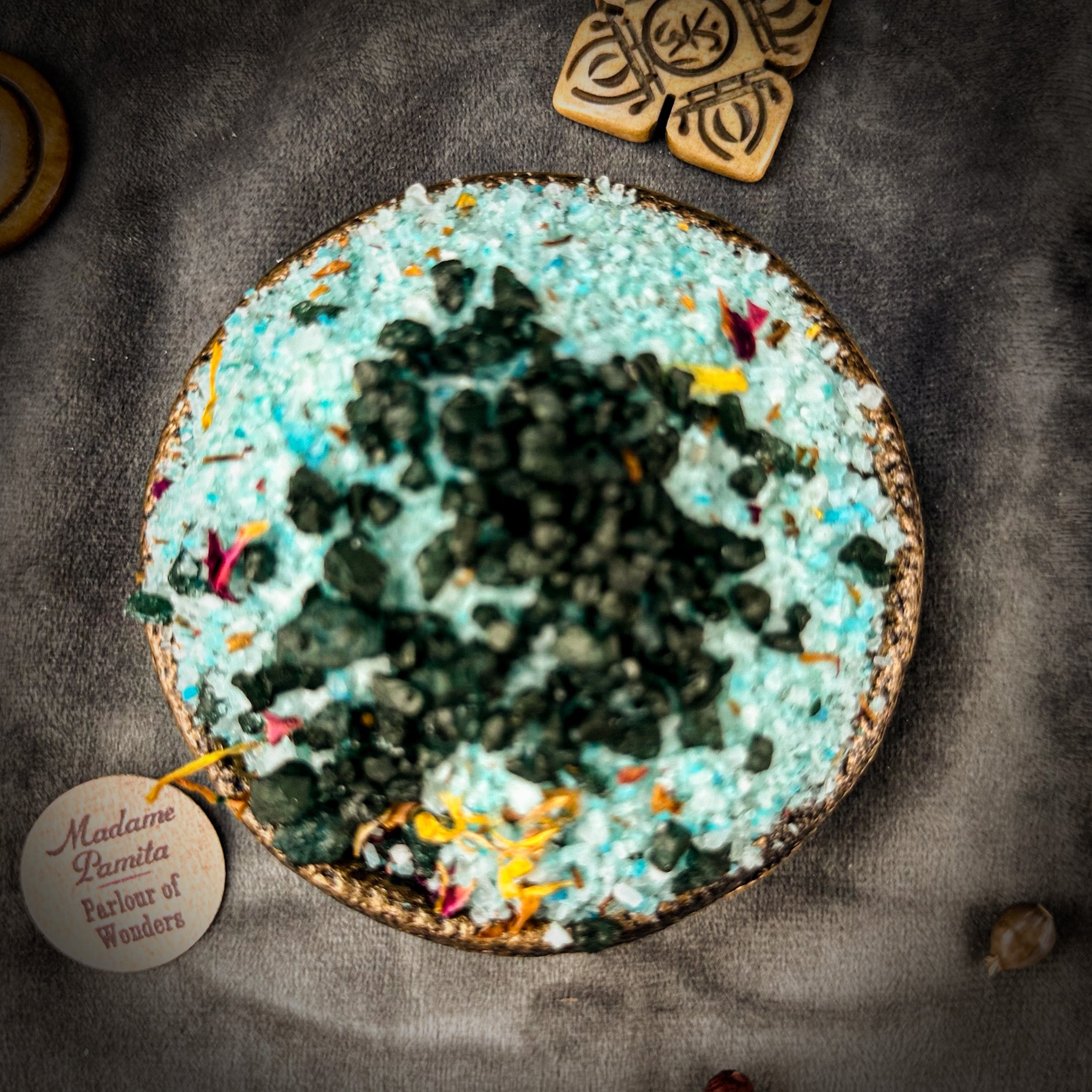 Small jar of Parlour of Wonders Santa Muerte Bath Crystals with colorful labels and crystals inside for relaxing bath experience.