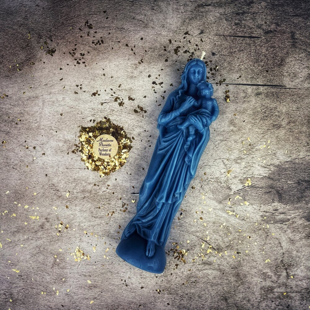 Blue beeswax Mother Mary spell candle by Parlour of Wonders, featuring detailed religious imagery for divine protection and love magic.