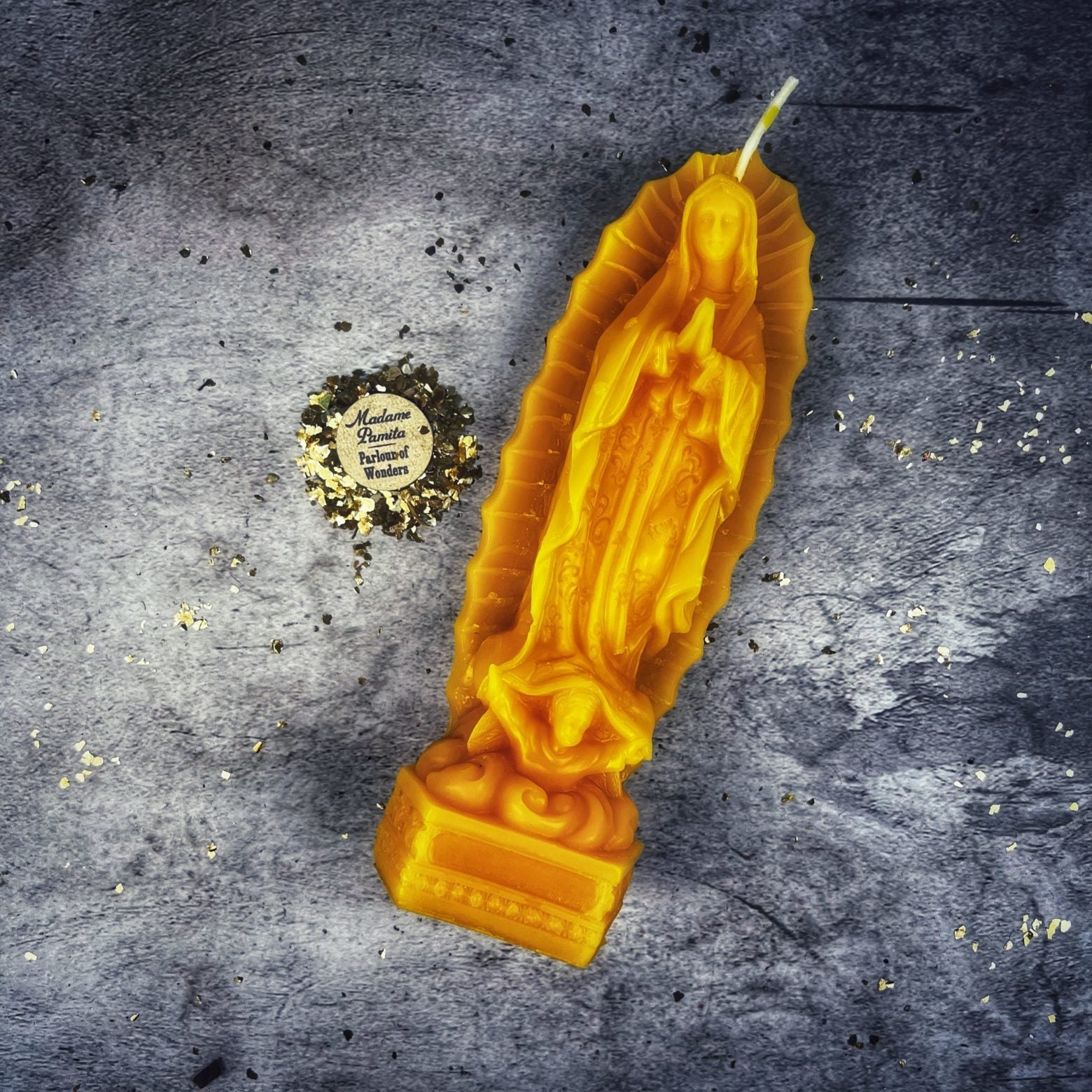 Blue beeswax candle featuring Nuestra Señora de Guadalupe, symbolizing divine mother and miracles, by Parlour of Wonders.